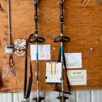 photo of string trimmer tools mounted on a wall