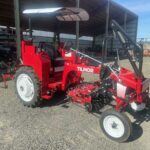 photo of a Tilmor cultivator tractor, with red paint and implements beneath the carriage between the wheels